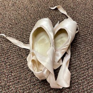 Used pointe shoes with ribbons